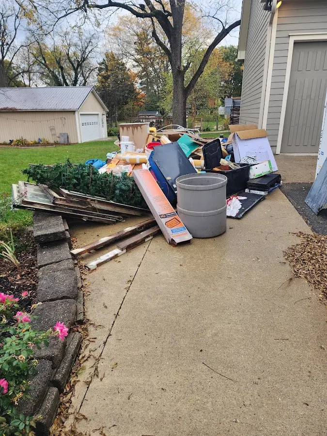 Dumpster being loaded with debris for 12 Yard Dumpster Rental in West Linn